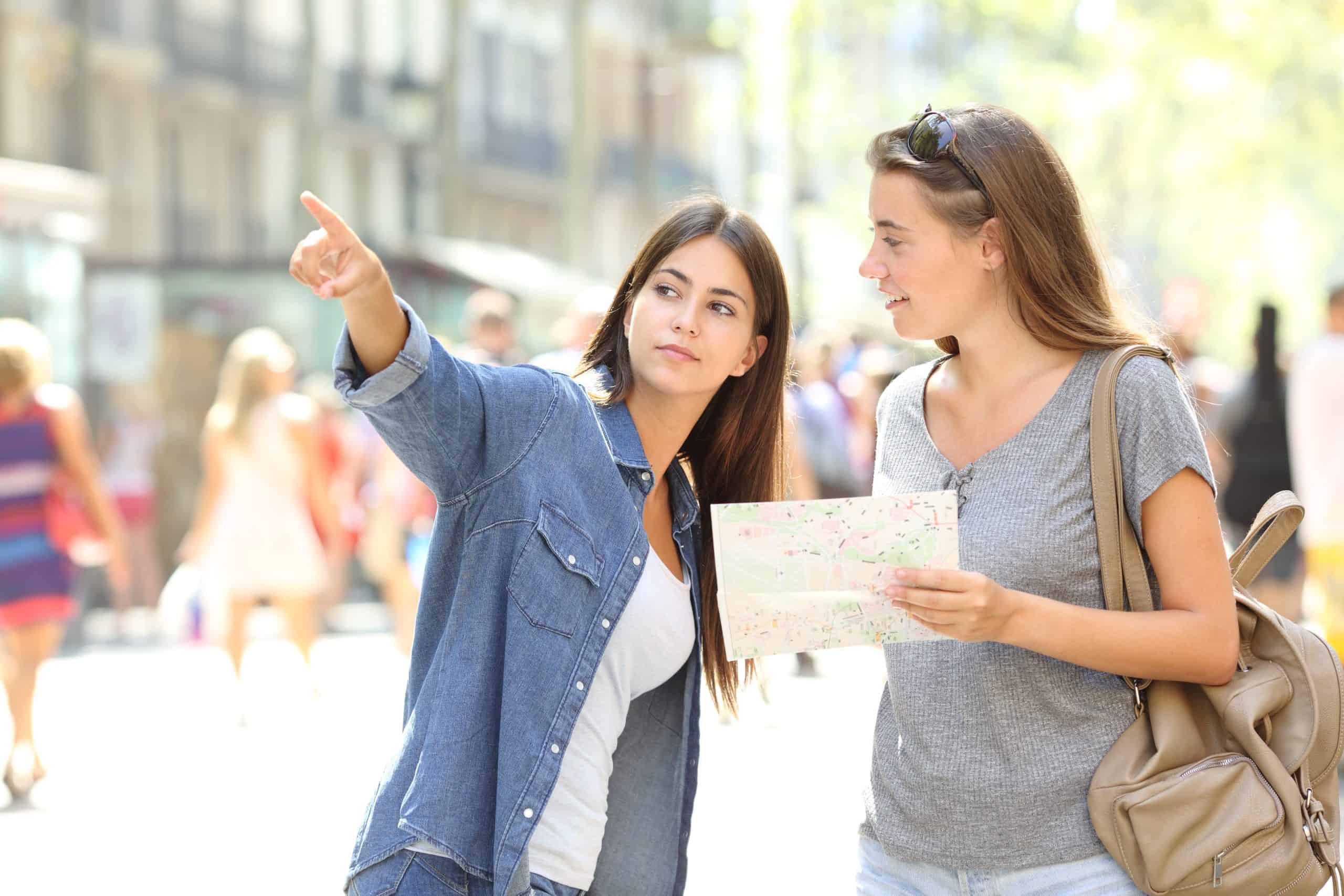 A woman is interviewing another women for directions.